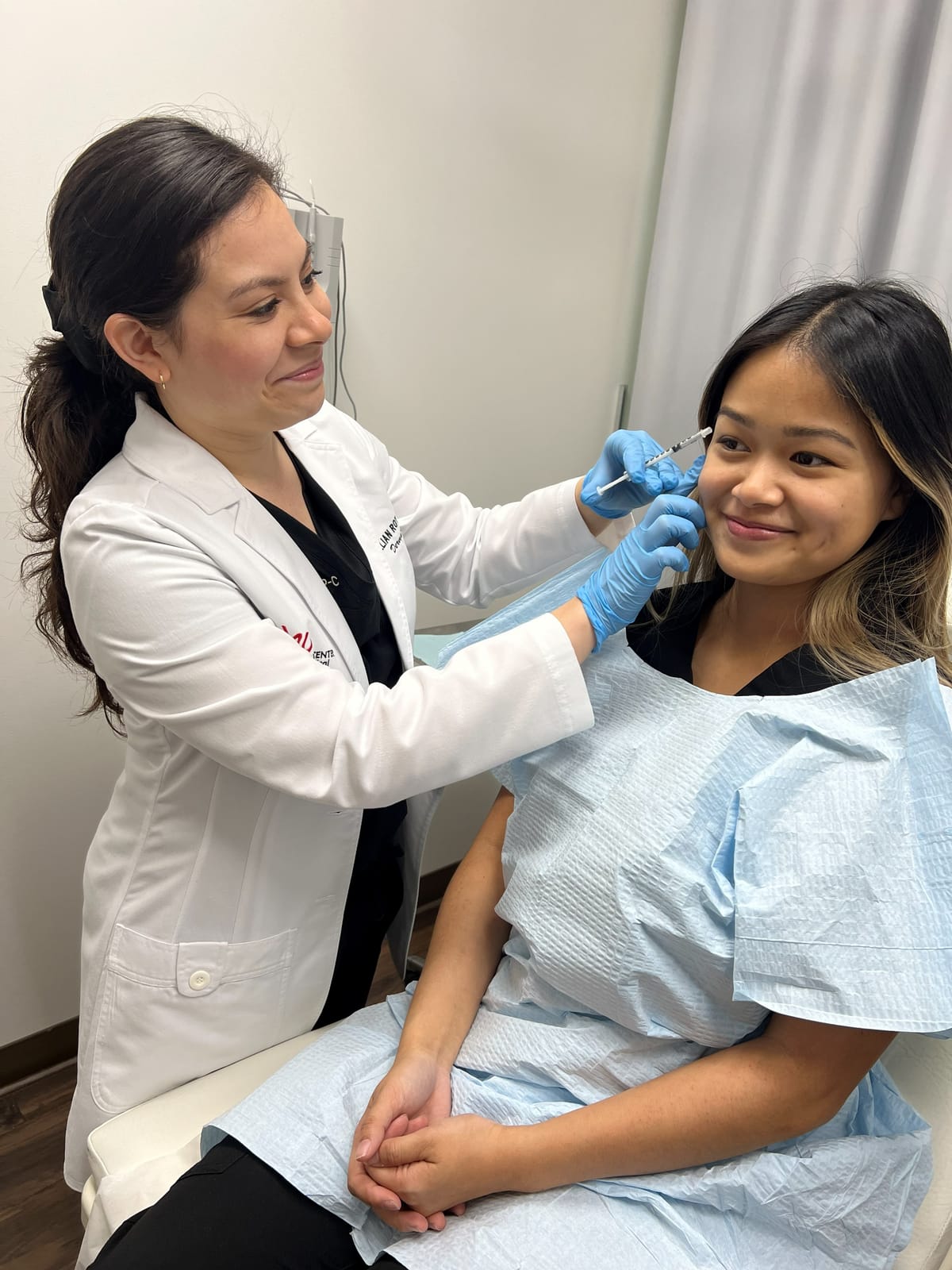 Jillian Roy, FNP-C, giving a smiling patient an injection treatment