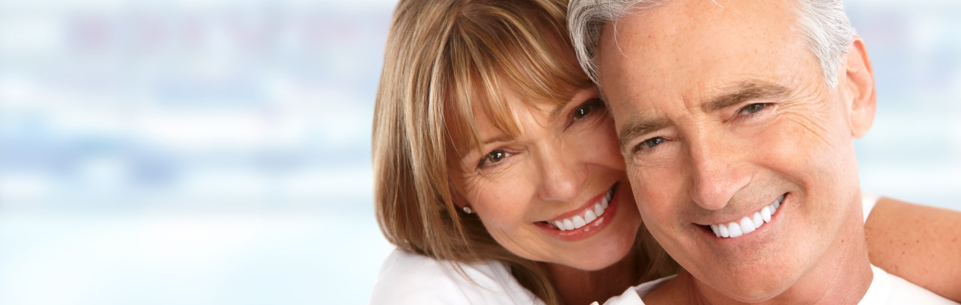 Smiling older couple posing cheek to cheek