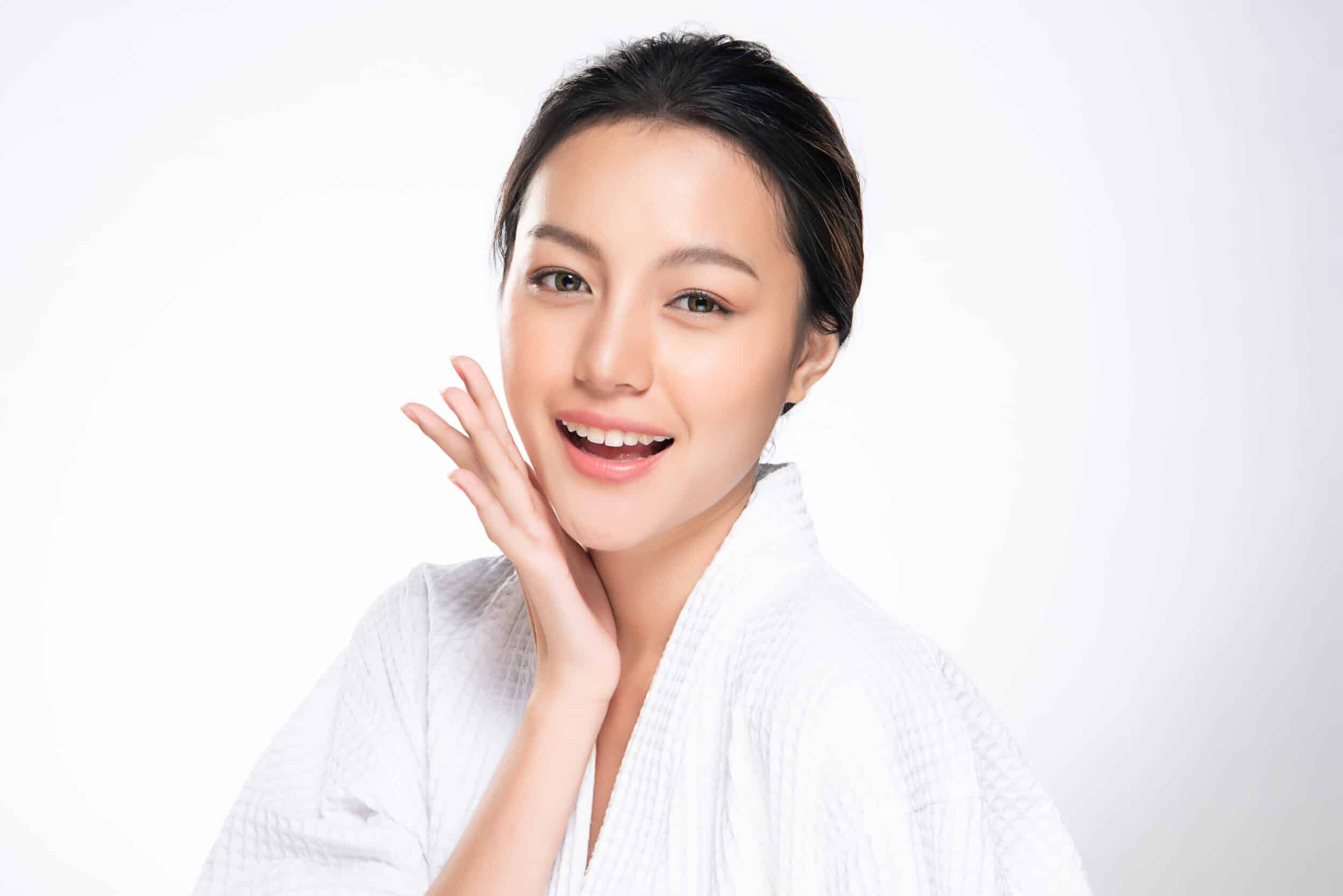 Woman smiling with clear, healthy skin after Omnilux light therapy in Los Angeles, CA
